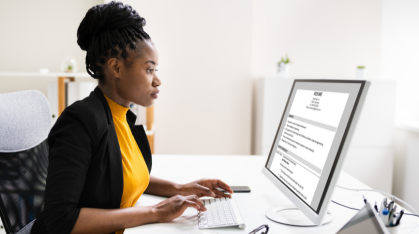 student working on resume at a computer